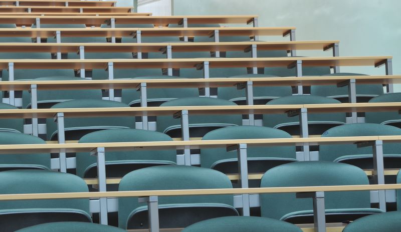Empty chairs at desks in a classroom 