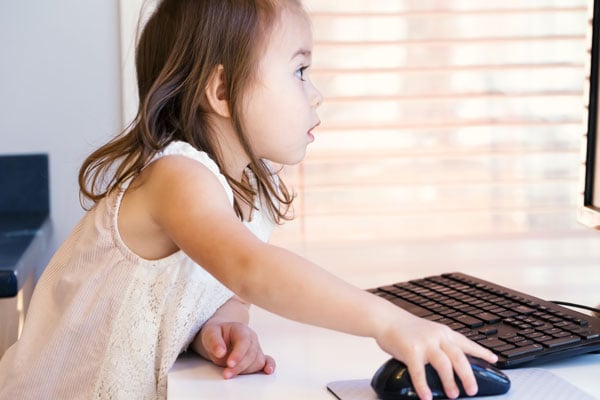 Child studying at computer for online class