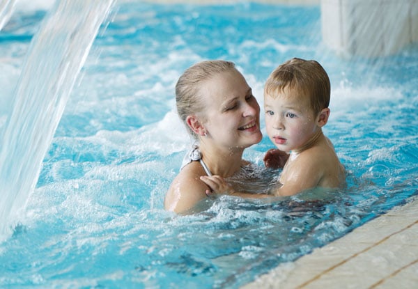 Young Child with Parent Learning to Swim