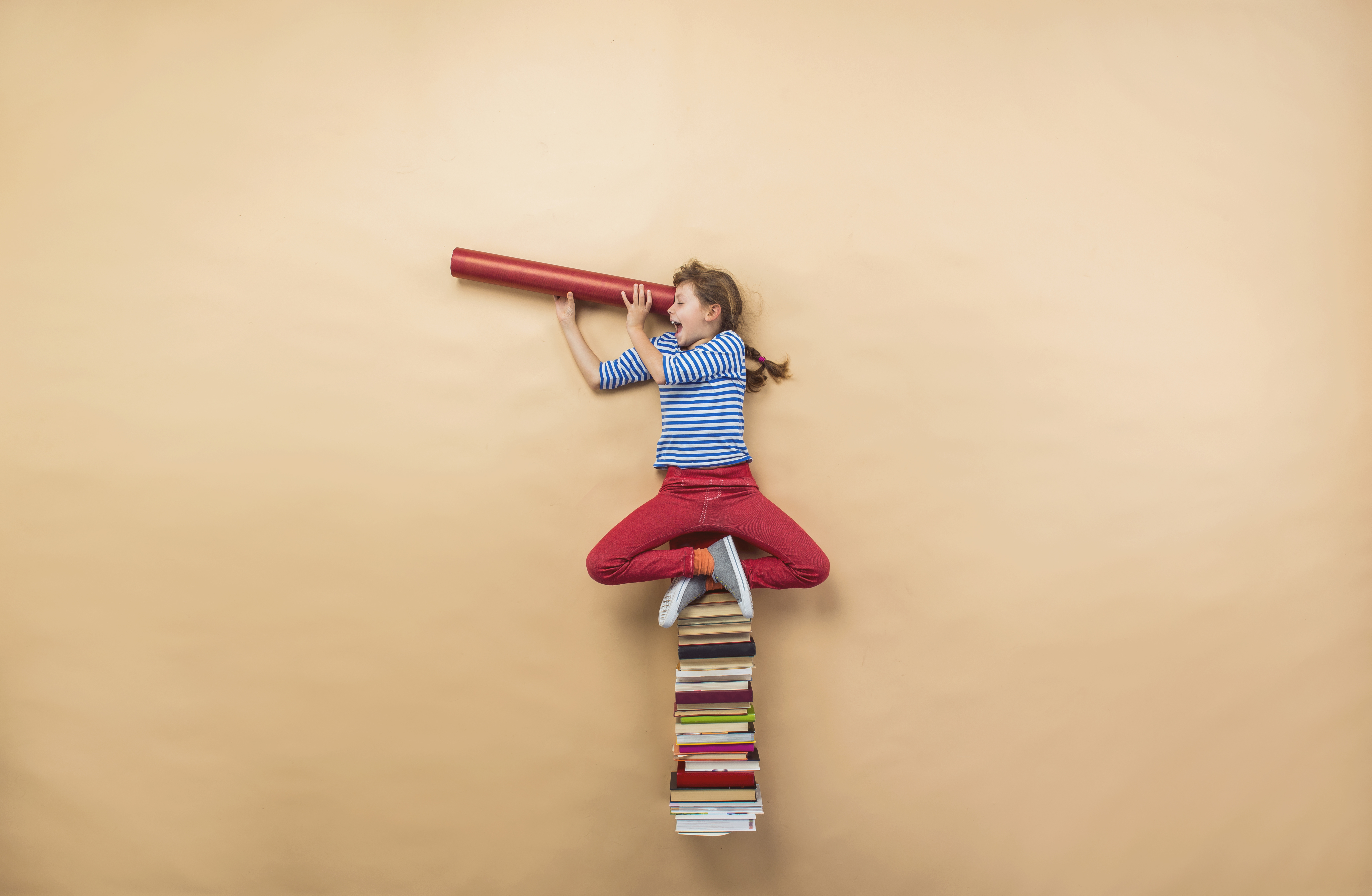 graphicstock-happy-girl-is-playing-with-group-of-books-in-studio_rR5wO1hbW